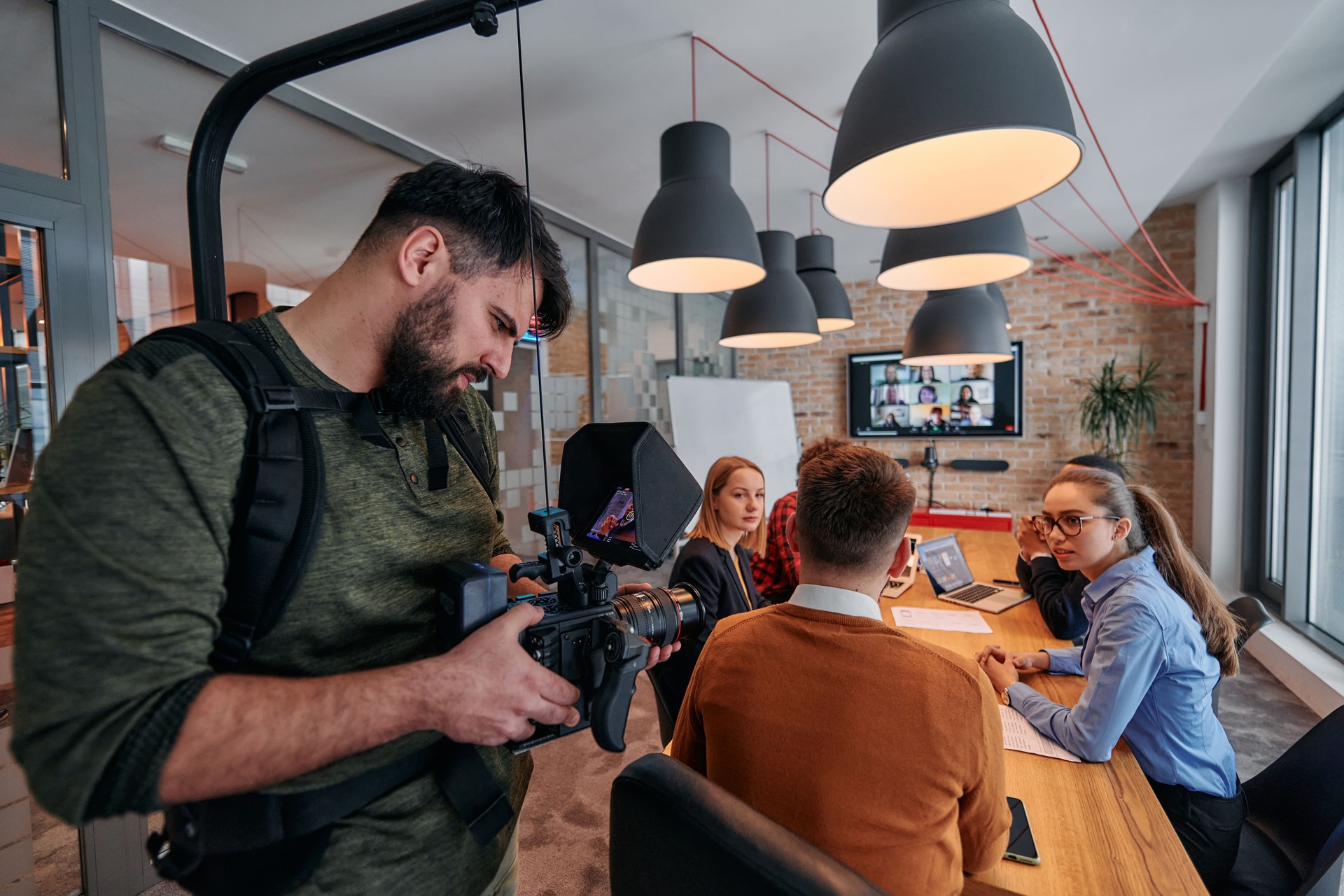 Capturing Corporate Dynamics: Videographer Films Business Meeting in Modern Office.