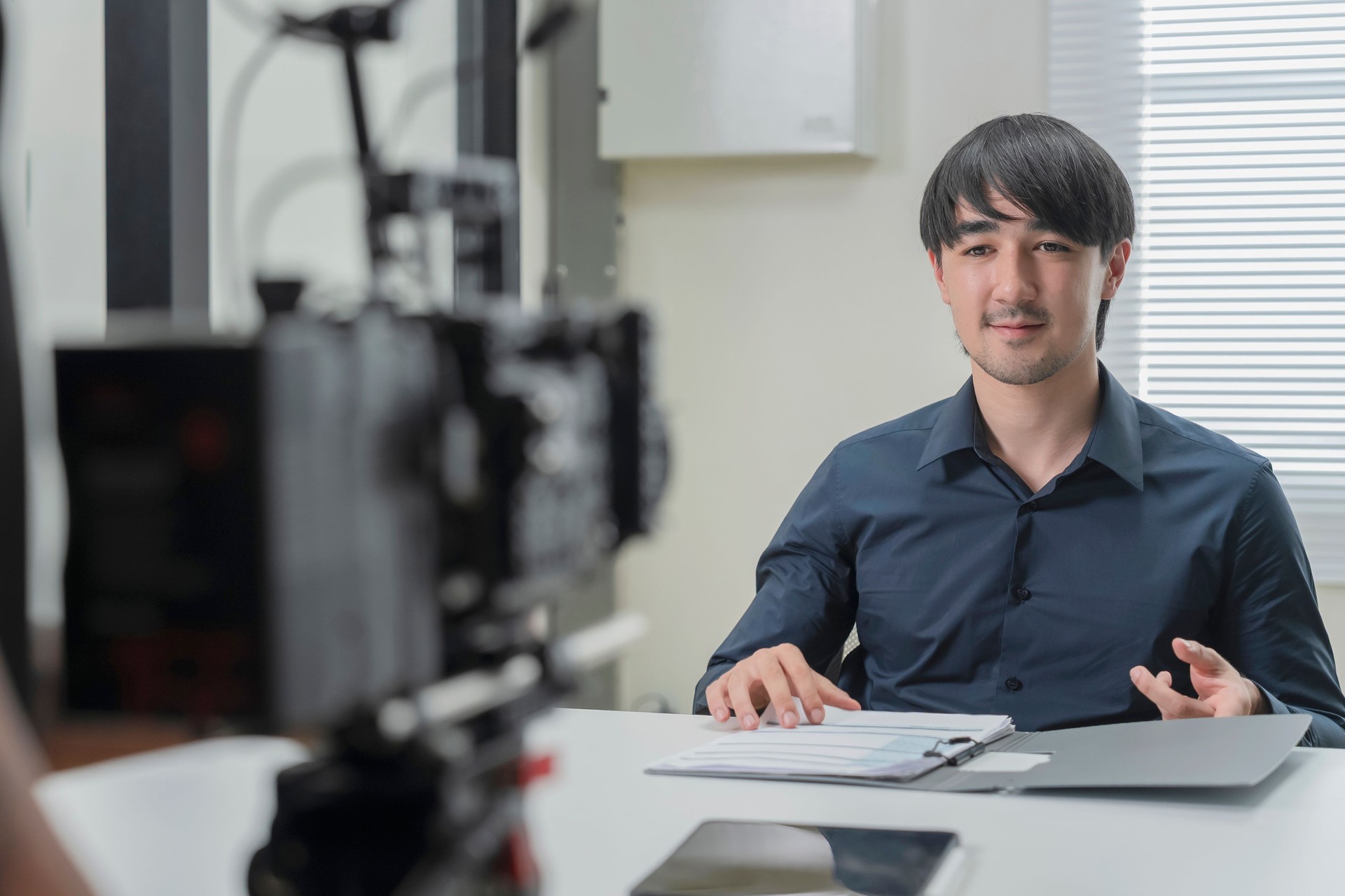 Caucasian businessman instructor recording a video of business class teacher during e-learning class Man records training. Live streaming a business class trick and lesson